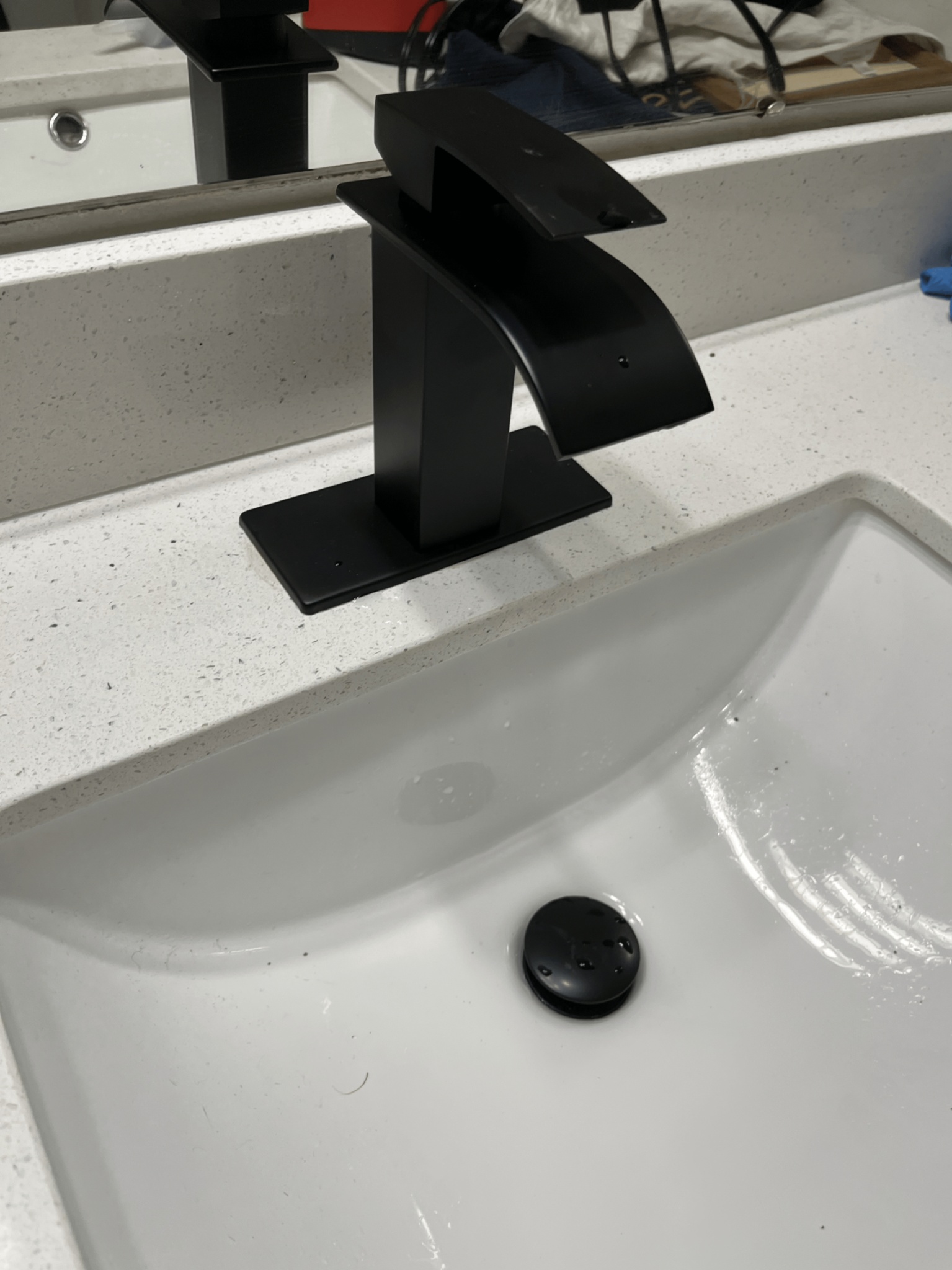 Matte black waterfall faucet installed on bathroom vanity