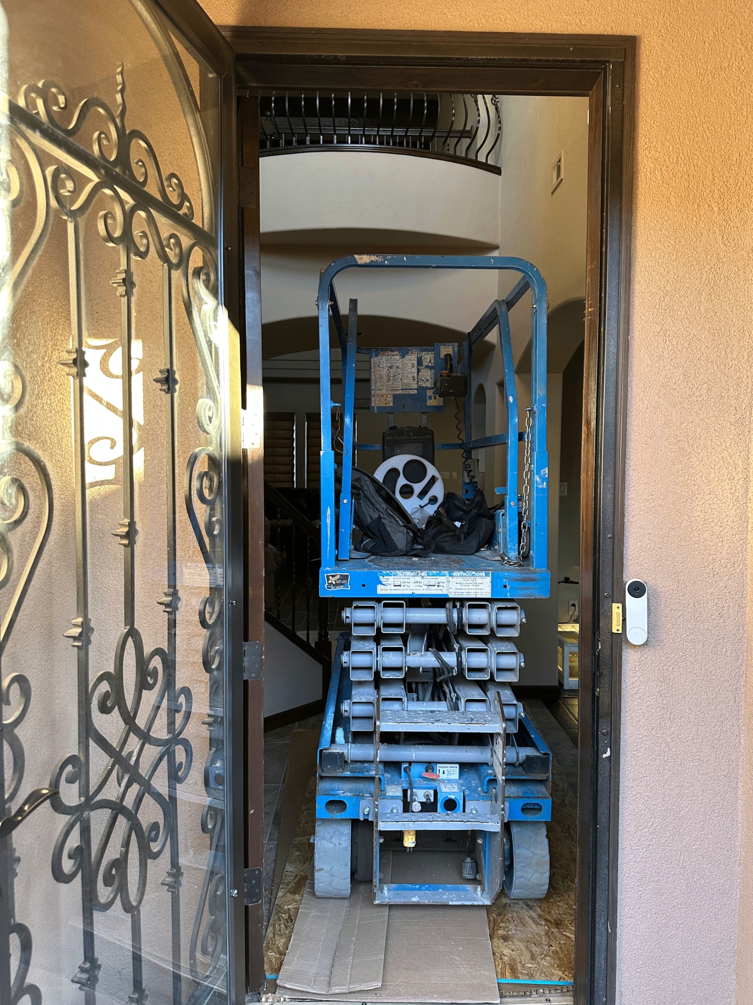Scissor lift used inside a home to swap a 25ft chandelier