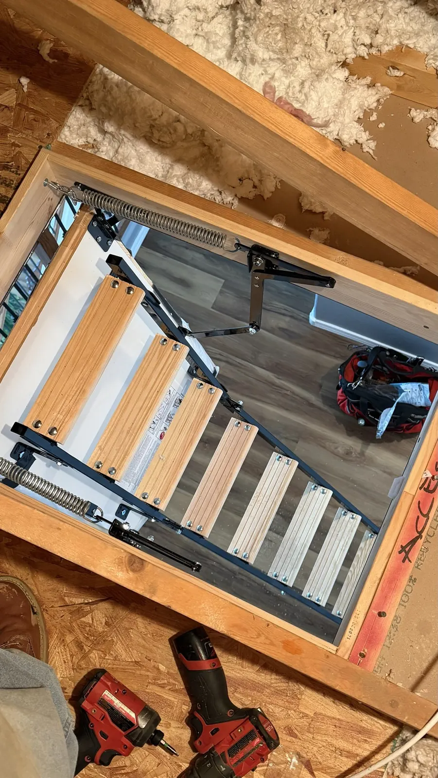Folding attic ladder installed in a new framed opening