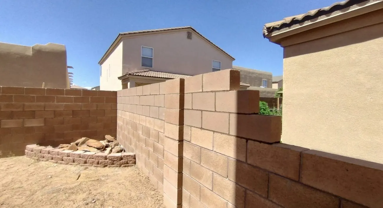 CMU block wall extension built between two Albuquerque homes