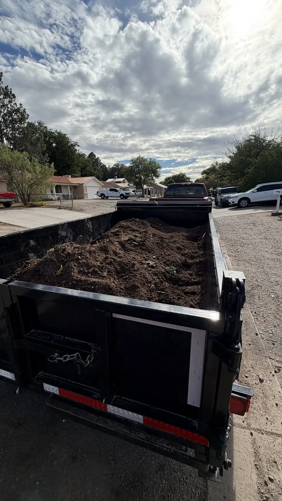Dump trailer loaded with dirt and roots from a yard cleanup