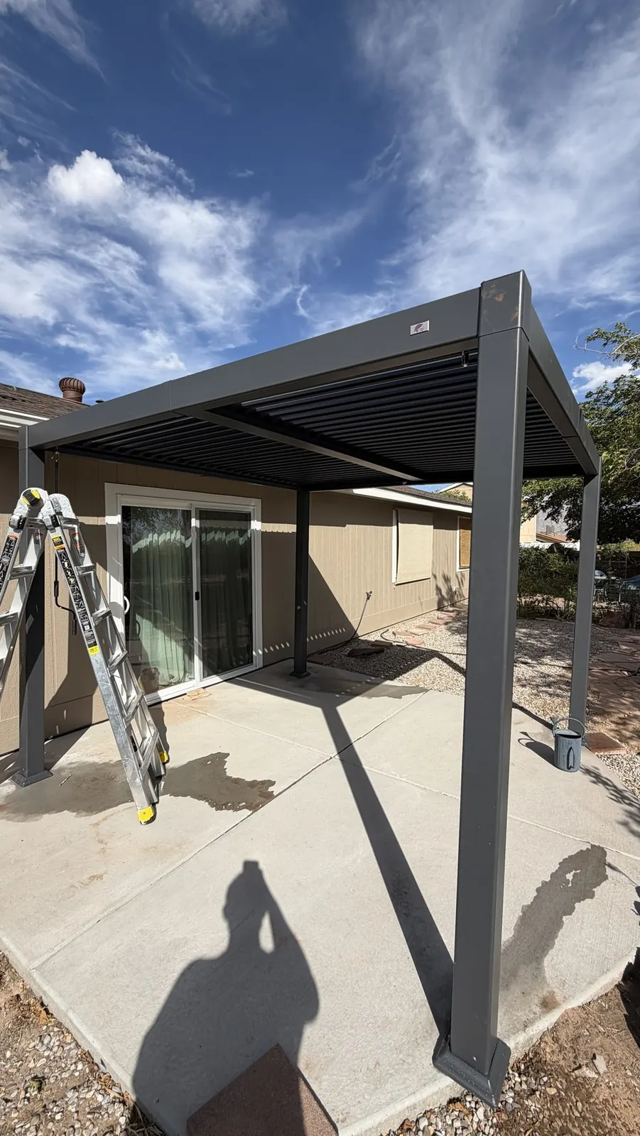 Louvered aluminum pergola installed over a back patio
