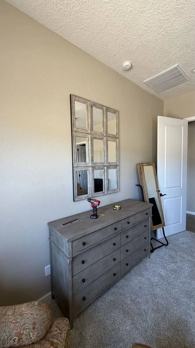 Grid mirror hung level above a dresser