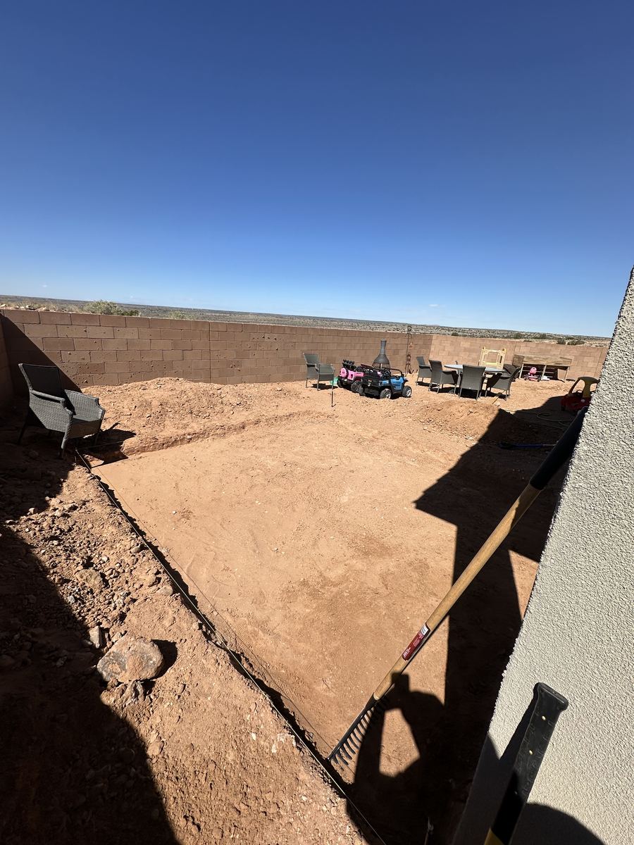 Backyard excavation squared and leveled with string lines before paver patio install