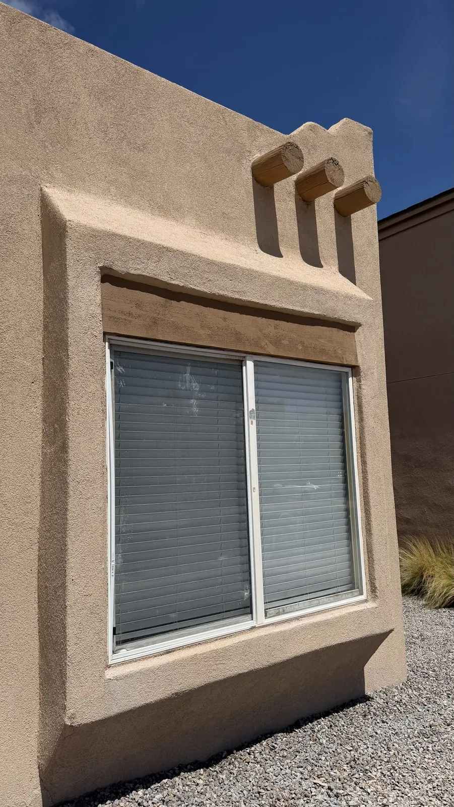 Finished window header blended into the stucco