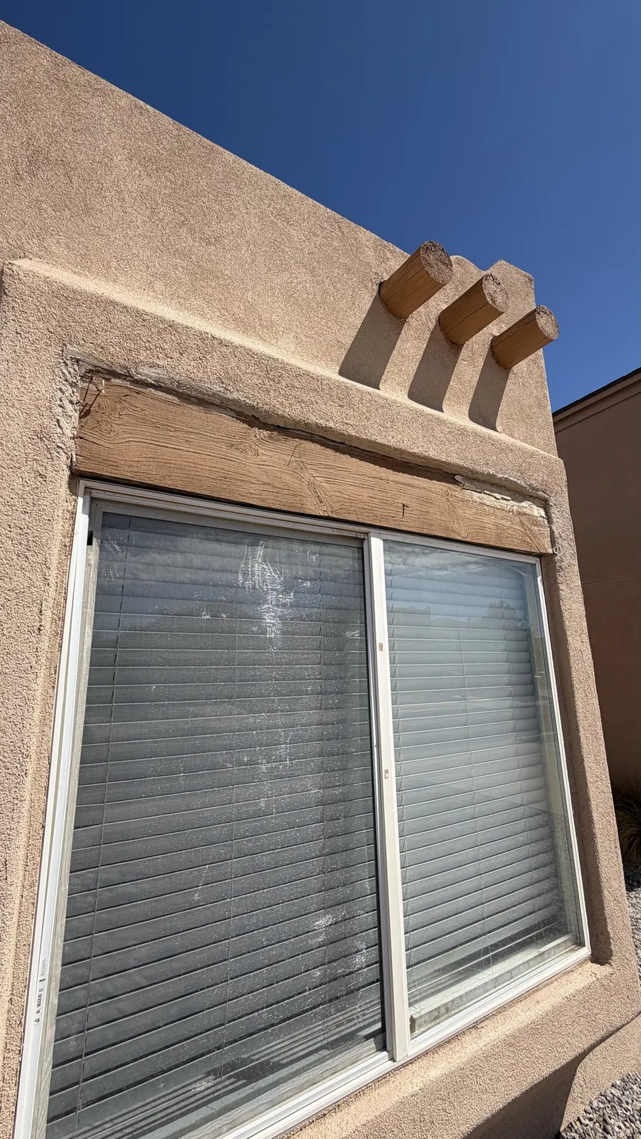 Rotted wood window header before repair