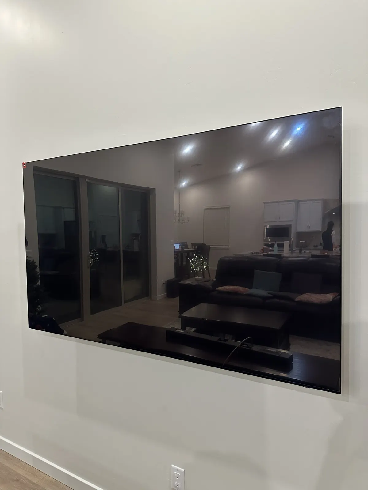 Large frameless TV flush mounted on a white wall, Albuquerque