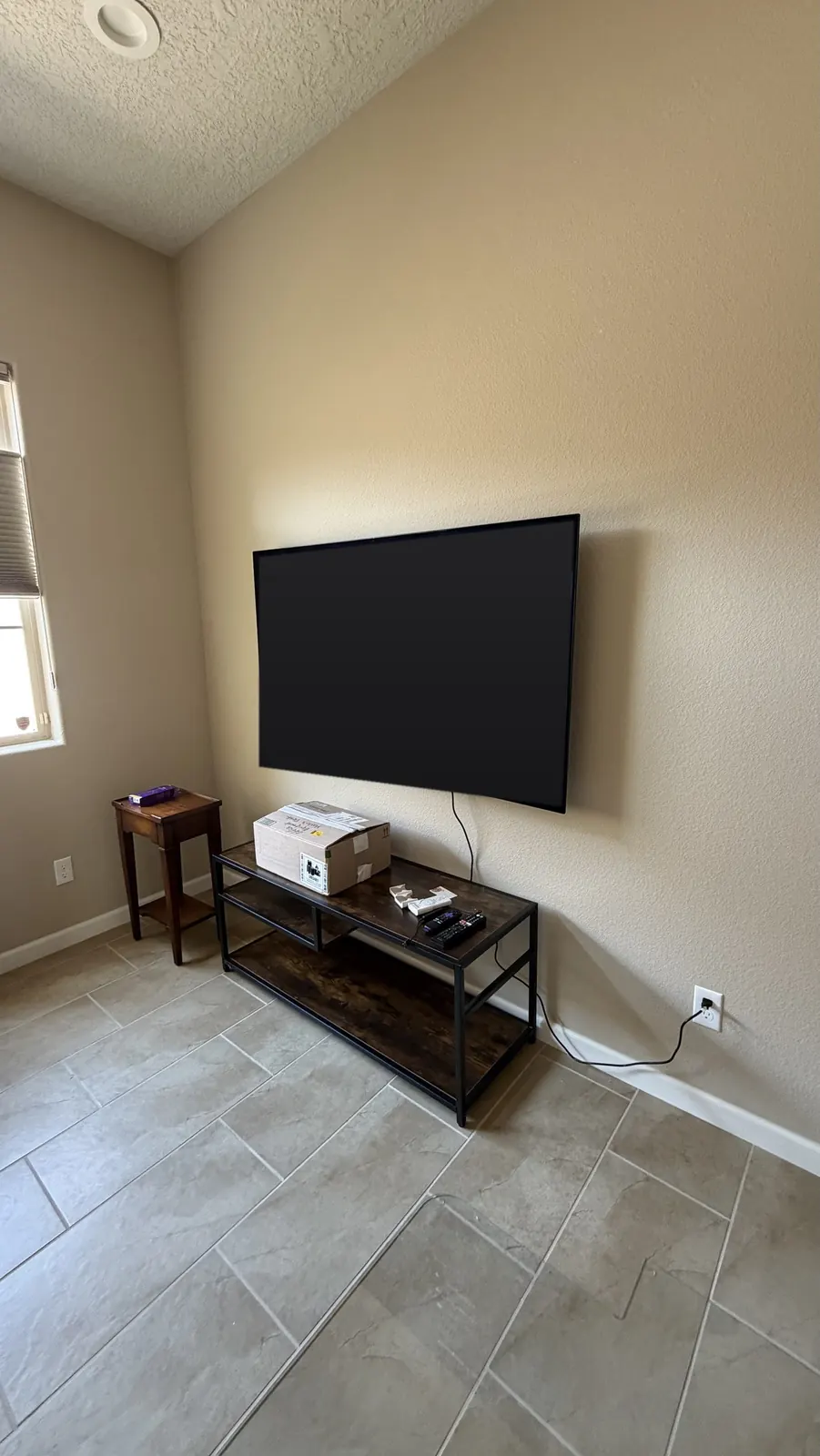 TV wall mounted at viewing height in a vaulted-ceiling room